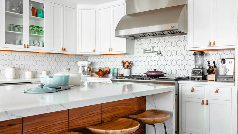 Bright white kitchen with open shelving and a wood table